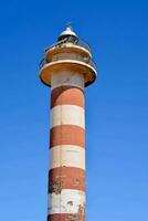 a lighthouse tower with red and white stripes photo