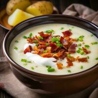 AI generated A creamy and comforting potato soup with bits of crispy bacon and a dollop of sour cream on top photo