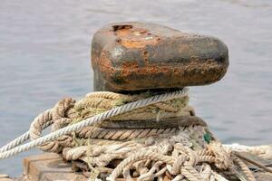 a rusted anchor with ropes photo