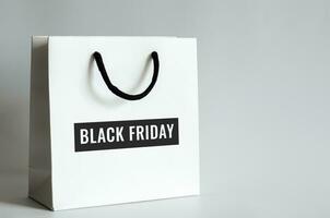 White shopping bag with Black Friday word on white background for Black Friday shopping sale concept. photo