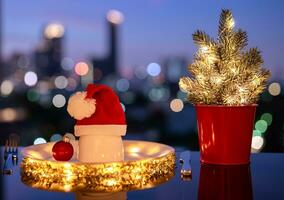 Christmas dining concept with white plate which have small bowl that have santa claus hat on it put on table with city bokeh light background. photo