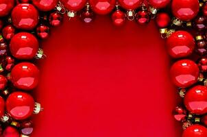 Red baubles put on red background for Christmas holiday concept. photo