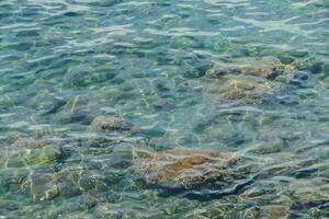 the water is clear with rocks photo