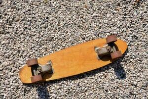 an old skateboard laying on the ground photo