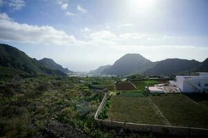 a view of the mountains and white buildings photo