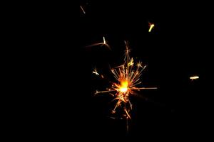 A lit sparkler showing bright sparks photo