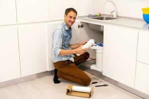 Plumber installs a water filter. water filter. photo