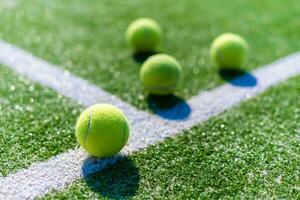 View of empty lawn tennis court with tennis ball photo