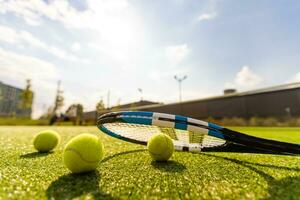 Tennis Racket on empty tennis grass court photo