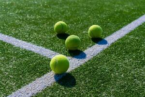 View of empty lawn tennis court with tennis ball photo