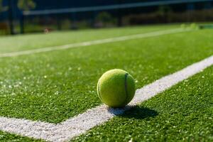 View of empty lawn tennis court with tennis ball photo