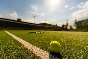 View of empty lawn tennis court with tennis ball photo