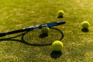 Green ball falling on floor nearly white lines of outdoor tennis court in public park photo