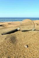 a magnifying glass on the beach photo