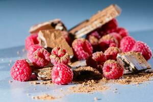 raspberries with chocolate on gray photo