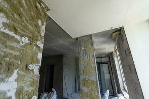 Small apartment without repair in a new building. A room in an unfinished house. Walls of foam block and concrete floor in a tiny apartment. photo