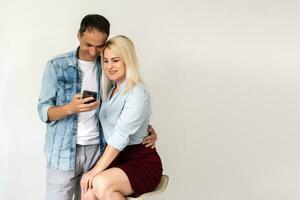 Happy couple using smartphone together photo