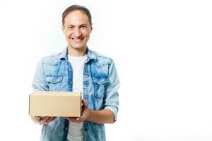 smiling delivery man holding a big parcel isolated on white photo