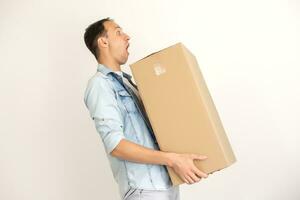 Smiling delivery man giving cardbox on white background photo