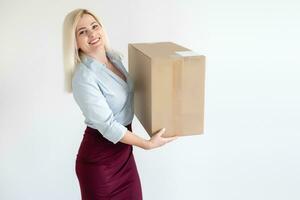 A young beautiful caucasian woman holding a box in her hands. photo