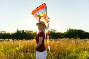 woman with a kite in the field photo