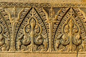 carved stone wall with intricate designs photo