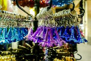 colorful eiffel tower key chains hanging on a rack in a store photo