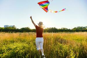 woman with a kite in the field photo