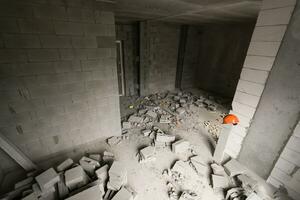 Break the wall for renovation and build the door for entrance of building. Wheelbarrow with broken bricks in site construction. photo