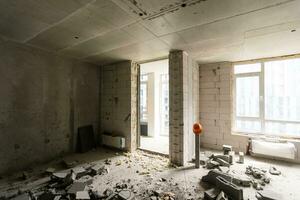 Break the wall for renovation and build the door for entrance of building. Wheelbarrow with broken bricks in site construction. photo