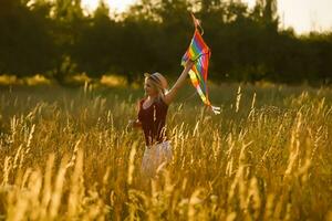 woman with a kite in the field photo