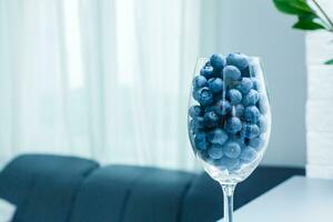 ripe blueberries in a glass goblet. Berries closeup photo