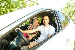 Young couple sitting in car photo