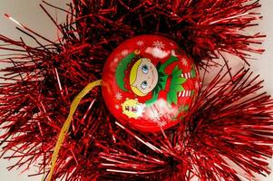 a red ornament with a christmas elf on it photo