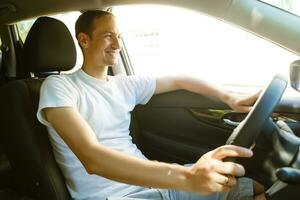 Portrait of an handsome guy driving his car photo