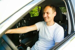 Portrait of an handsome guy driving his car photo