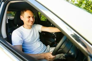 Portrait of an handsome guy driving his car photo