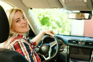 Smiling woman sitting in car photo