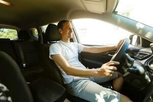 Portrait of an handsome guy driving his car photo