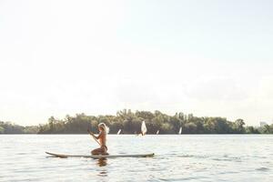 A beautiful woman practicing paddle on a beautiful sunny day photo