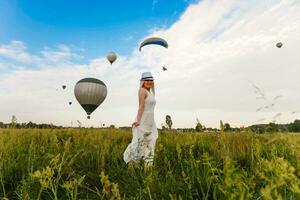 Amazing view with woman and air balloon. Artistic picture. Beauty world. The feeling of complete freedom photo