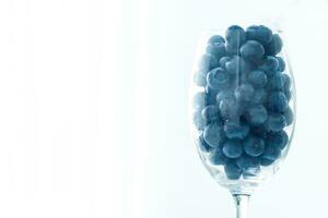 ripe blueberries in a glass goblet. Berries closeup photo