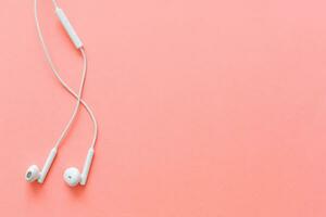 Flat lay concept headphones on pastel backgrounds. headphones on a pink background, top view, copyspace. Trendy colorful photo. Minimal style with colorful paper backdrop. photo