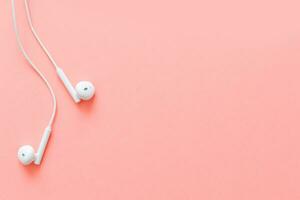 Flat lay concept headphones on pastel backgrounds. headphones on a pink background, top view, copyspace. Trendy colorful photo. Minimal style with colorful paper backdrop. photo