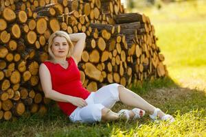 Beautiful Young Woman Outdoors. Enjoy Nature. Healthy Smiling Girl in Green Grass. photo