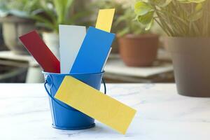 Colorful paper inside of a blue bucket with copy space. photo