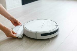 Robotic vacuum cleaner. Container with garbage from a smart robot vacuum cleaner. housework and technology concept photo