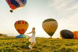 Amazing view with woman and air balloon. Artistic picture. Beauty world. The feeling of complete freedom photo