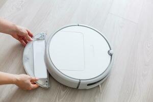 Robotic vacuum cleaner. Container with garbage from a smart robot vacuum cleaner. housework and technology concept photo
