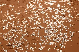 Peach Fuzz sparkles on a red background. Festive backdrop for your projects. photo